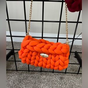 Orange handmade chunky purse with gold chain strap.